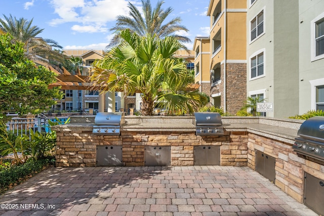 view of patio featuring area for grilling and a grill