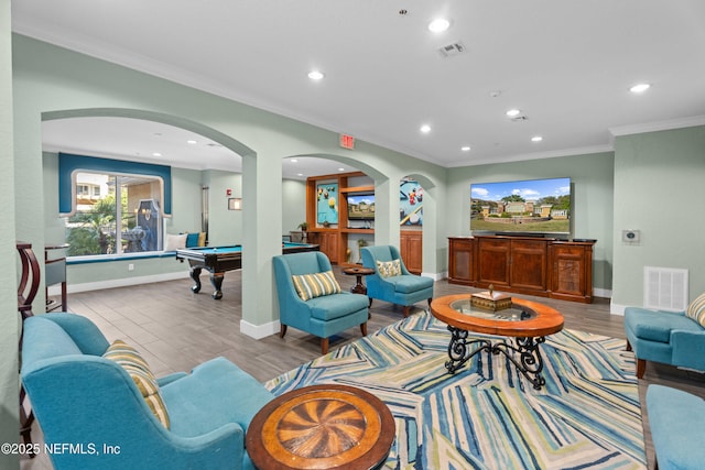 living area with ornamental molding, wood finished floors, billiards, and visible vents