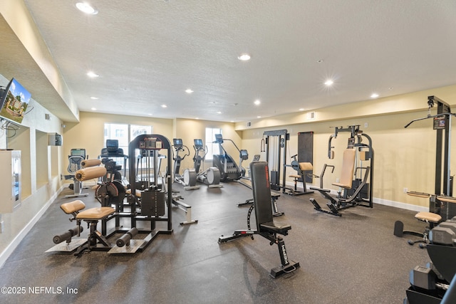 gym featuring baseboards, a textured ceiling, and recessed lighting