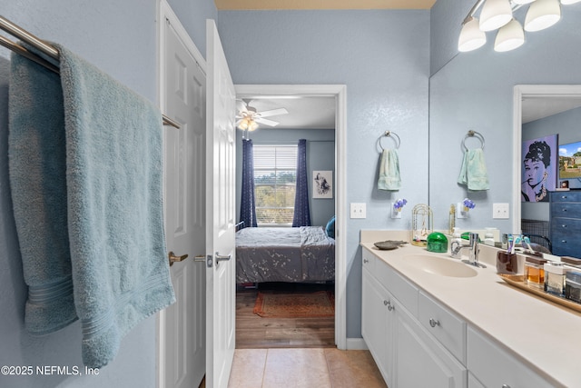 ensuite bathroom featuring ceiling fan, vanity, ensuite bath, and tile patterned floors