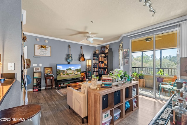 living room with ceiling fan, ornamental molding, and dark wood-type flooring