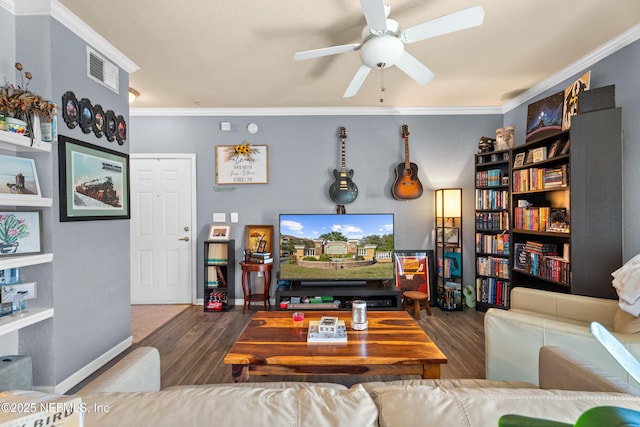 living room featuring a ceiling fan, visible vents, ornamental molding, and wood finished floors