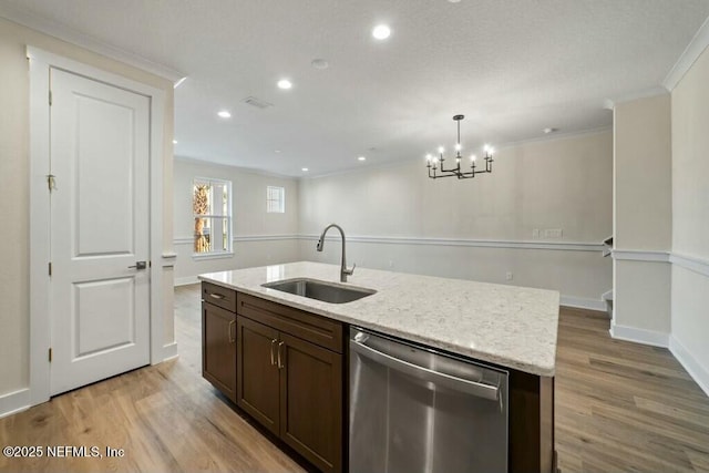 kitchen with dishwasher, ornamental molding, a sink, and light wood-style flooring