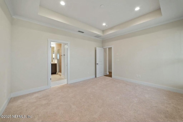 unfurnished bedroom featuring recessed lighting, a raised ceiling, light colored carpet, visible vents, and baseboards