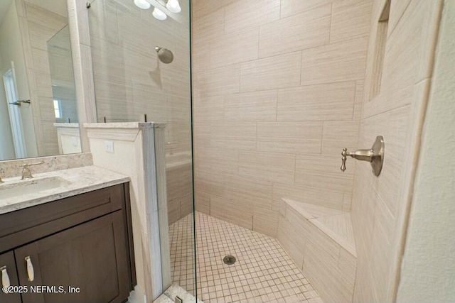 bathroom with a walk in shower and vanity