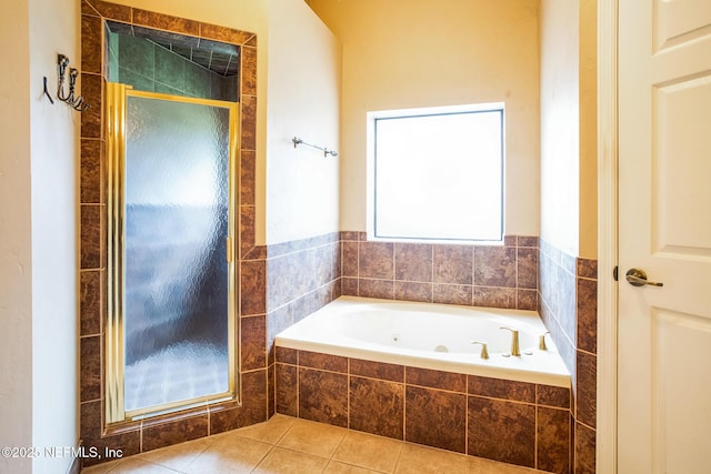 full bath featuring a tub with jets, a shower stall, and tile patterned floors