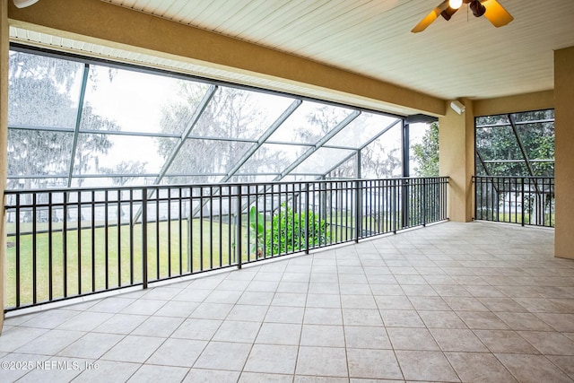 unfurnished sunroom with a ceiling fan