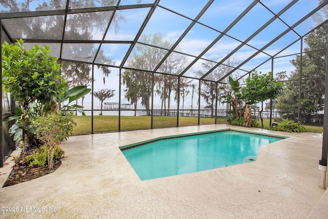 view of swimming pool with a patio area, glass enclosure, a fenced in pool, and a yard