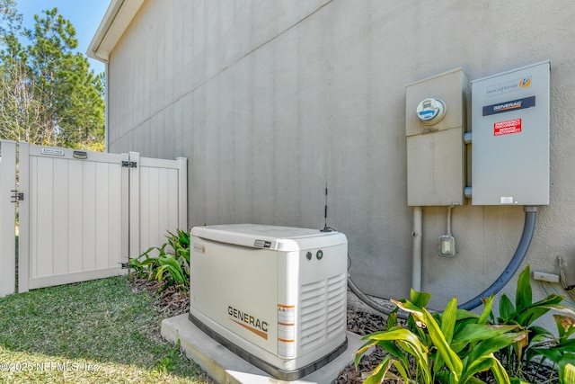 exterior details featuring a power unit, fence, and stucco siding