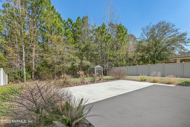 view of patio / terrace with a storage shed, an outbuilding, and a fenced backyard