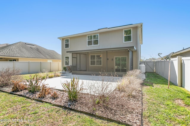 back of property featuring a patio, a fenced backyard, a sunroom, a lawn, and stucco siding