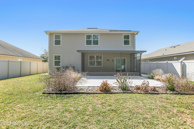 back of property with a patio area, fence, stucco siding, and a yard