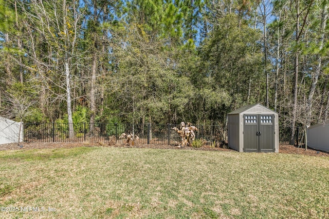 view of yard featuring an outbuilding, a shed, and a fenced backyard