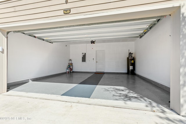 garage featuring electric panel, water heater, and baseboards