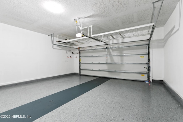 garage with baseboards and a garage door opener