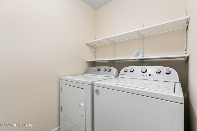 laundry area with laundry area and washer and clothes dryer