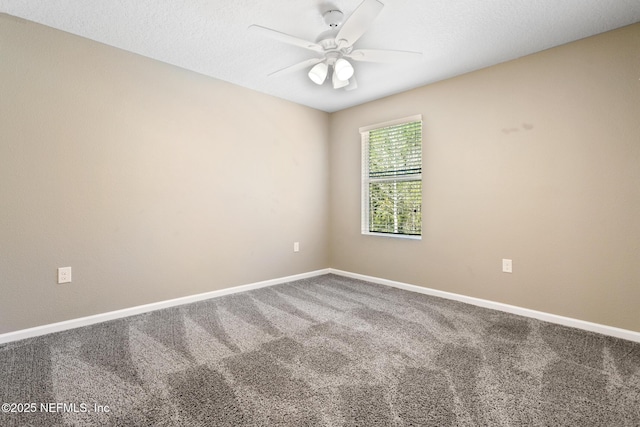 carpeted empty room with ceiling fan, a textured ceiling, and baseboards