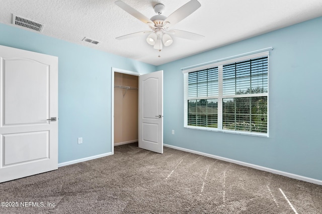 unfurnished bedroom featuring carpet flooring, visible vents, and baseboards