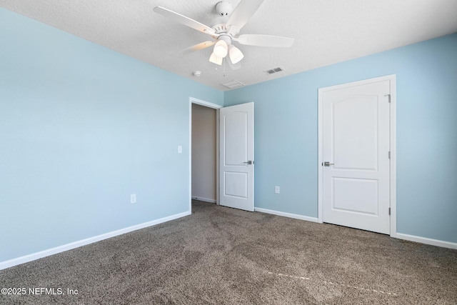 unfurnished bedroom with baseboards, visible vents, a ceiling fan, a textured ceiling, and carpet flooring