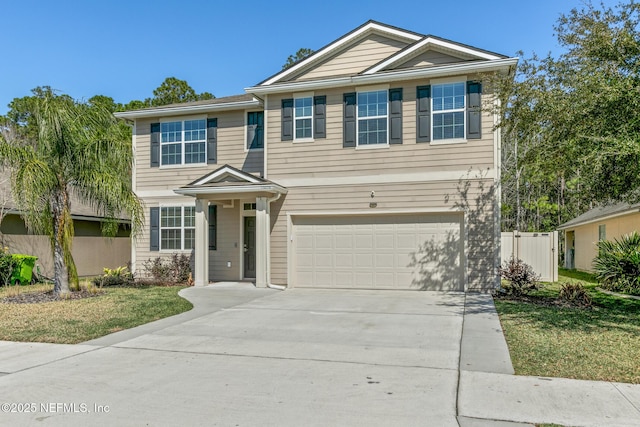 traditional home with a garage, driveway, and fence