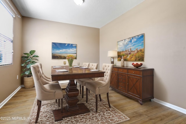 dining room with light wood finished floors and baseboards