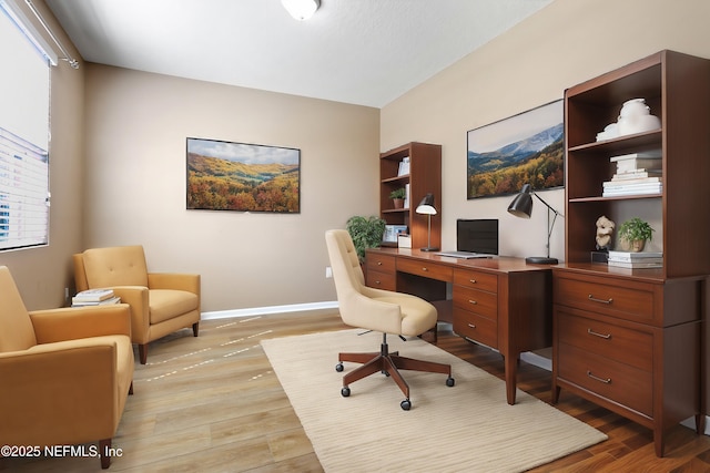 office area with light wood finished floors and baseboards