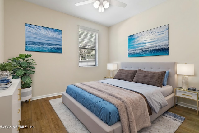 bedroom with ceiling fan, baseboards, and wood finished floors