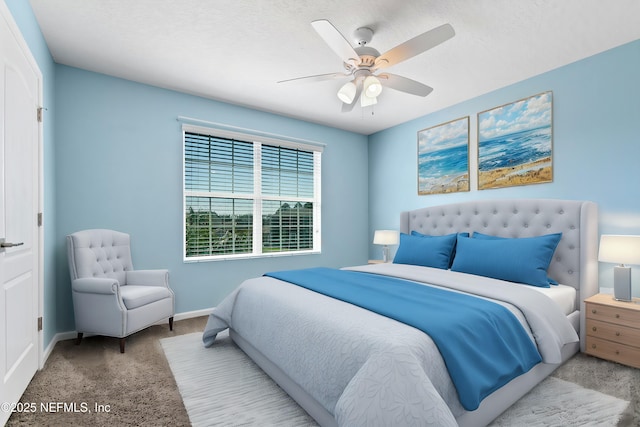 bedroom with carpet, ceiling fan, a textured ceiling, and baseboards