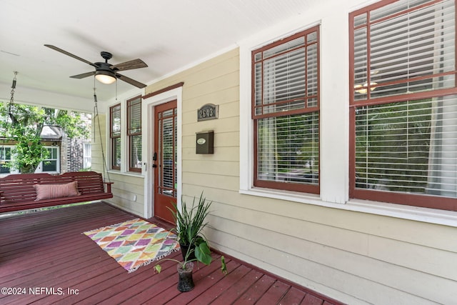 wooden terrace with a porch and a ceiling fan