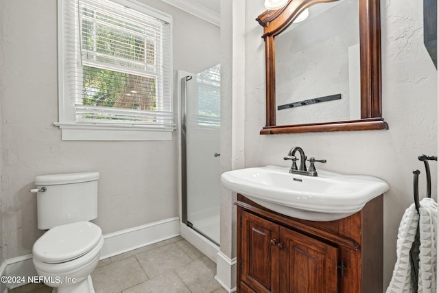 full bathroom with a stall shower, toilet, tile patterned floors, crown molding, and vanity