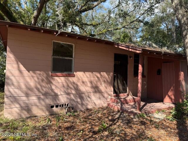 view of side of property with crawl space