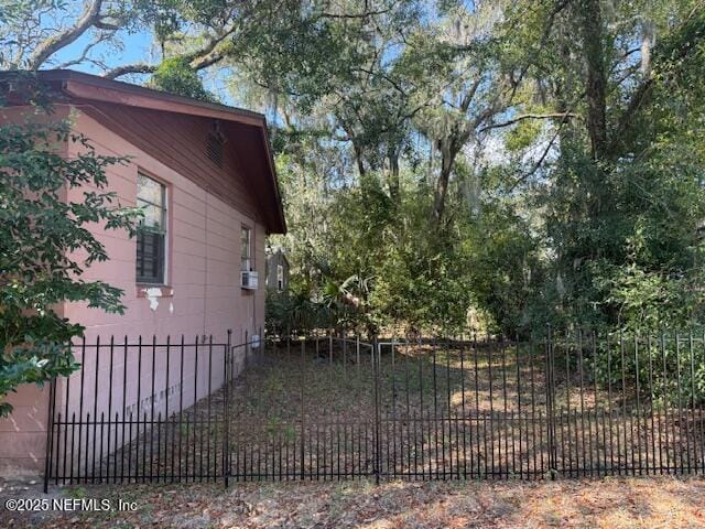 view of home's exterior featuring cooling unit and fence