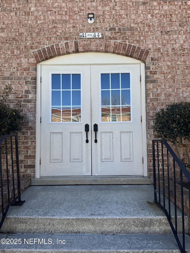 property entrance featuring brick siding