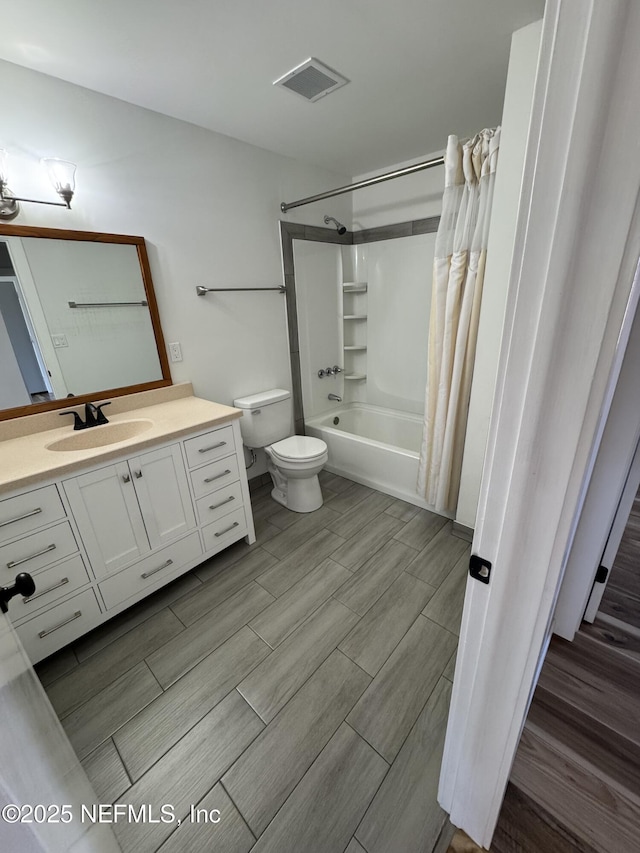 bathroom with visible vents, shower / bathtub combination with curtain, toilet, wood tiled floor, and vanity