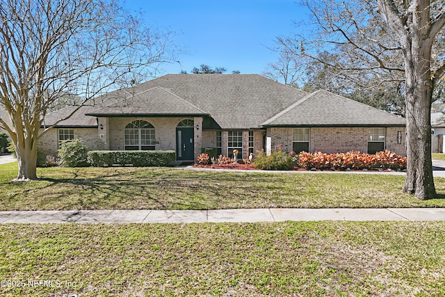 view of front of property with a front lawn and roof with shingles