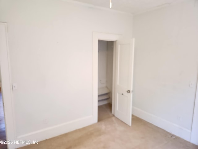 unfurnished bedroom with carpet floors and baseboards