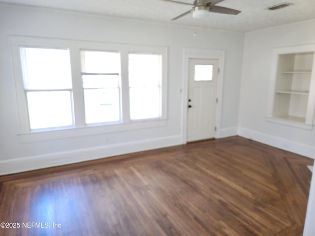 entrance foyer featuring a ceiling fan, visible vents, baseboards, and wood finished floors