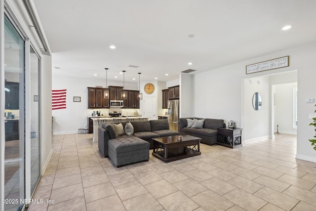 living room featuring recessed lighting, visible vents, baseboards, and light tile patterned flooring