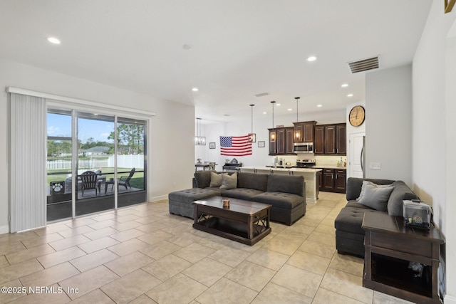 living room with recessed lighting, visible vents, baseboards, and light tile patterned flooring