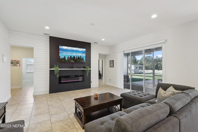 living area featuring a glass covered fireplace, light tile patterned flooring, and recessed lighting