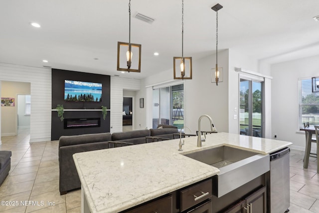 kitchen with dishwasher, open floor plan, a sink, and visible vents