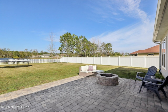 view of patio featuring a water view, an outdoor fire pit, and a fenced backyard