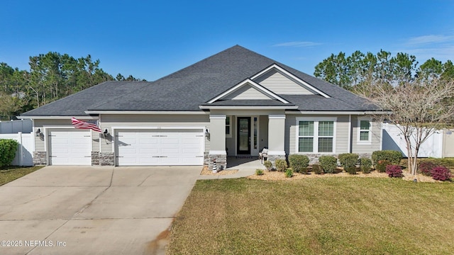 view of front of home featuring a garage, fence, driveway, and a front lawn