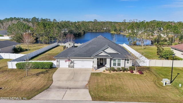 view of front of home with concrete driveway, a water view, a front yard, a garage, and fence private yard