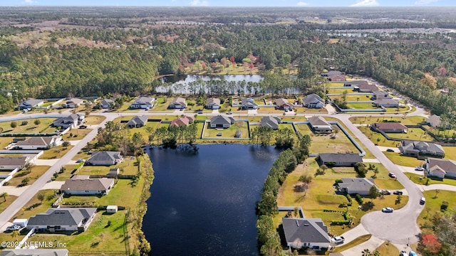 aerial view with a residential view, a water view, and a wooded view