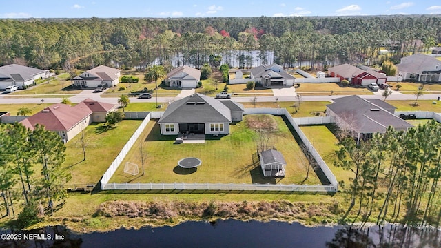 bird's eye view featuring a forest view, a water view, and a residential view