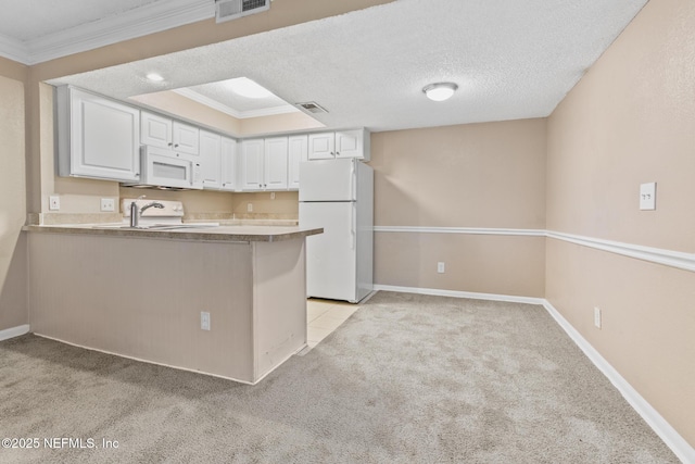 kitchen featuring visible vents, light carpet, white cabinets, a textured ceiling, and white appliances