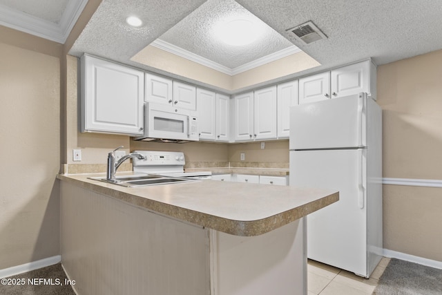 kitchen featuring visible vents, white cabinetry, a textured ceiling, white appliances, and a peninsula