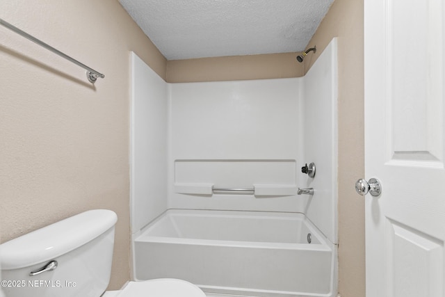 full bath featuring a textured ceiling, toilet, and bathing tub / shower combination