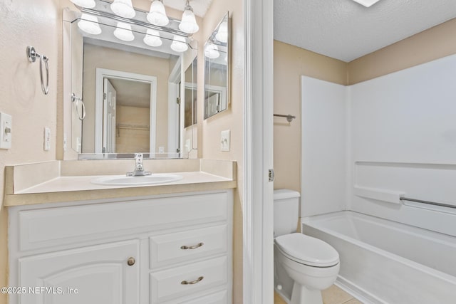 full bathroom with toilet, a textured ceiling, and vanity